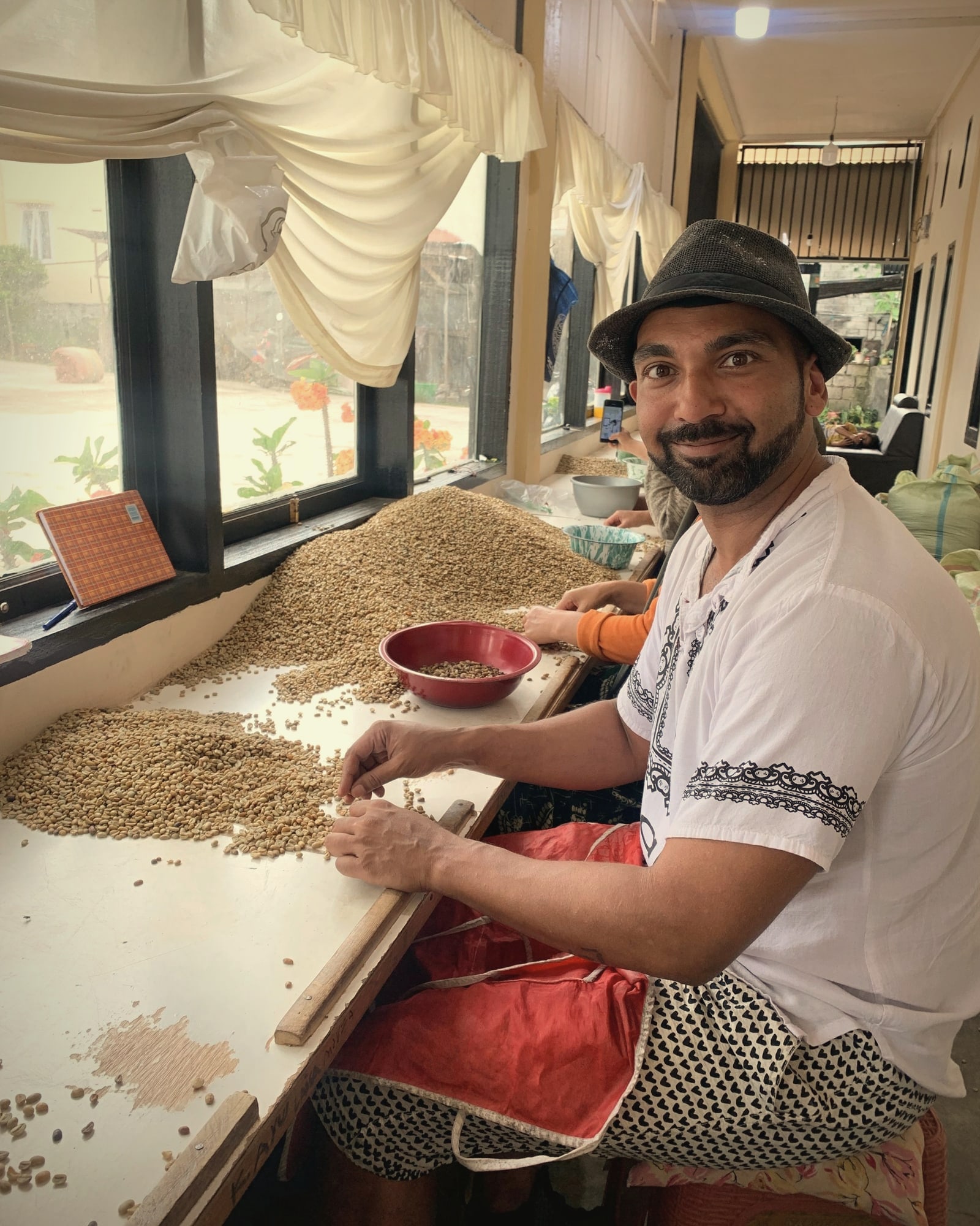 Gayo Wild's founder hand-sorting green coffee with the sorting team, April 2025