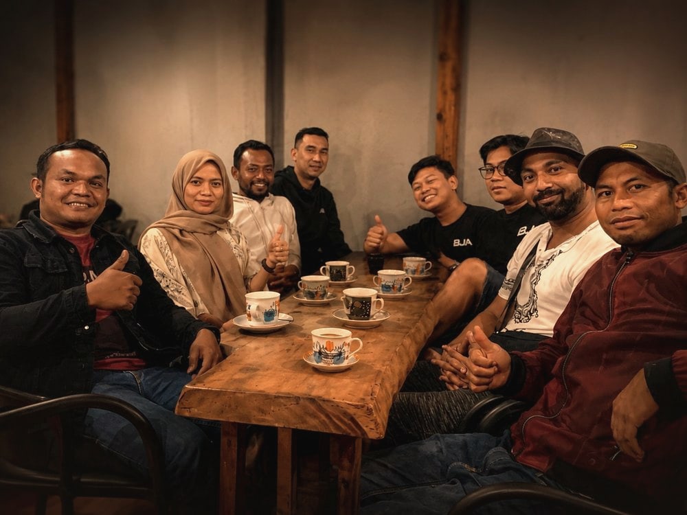 Gayo Wild's founder with coffee farmers and collectors around a table